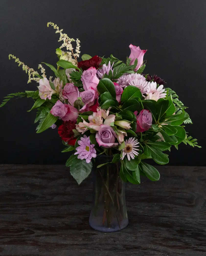 Bouquet of flowers in a vase on a dark surface
