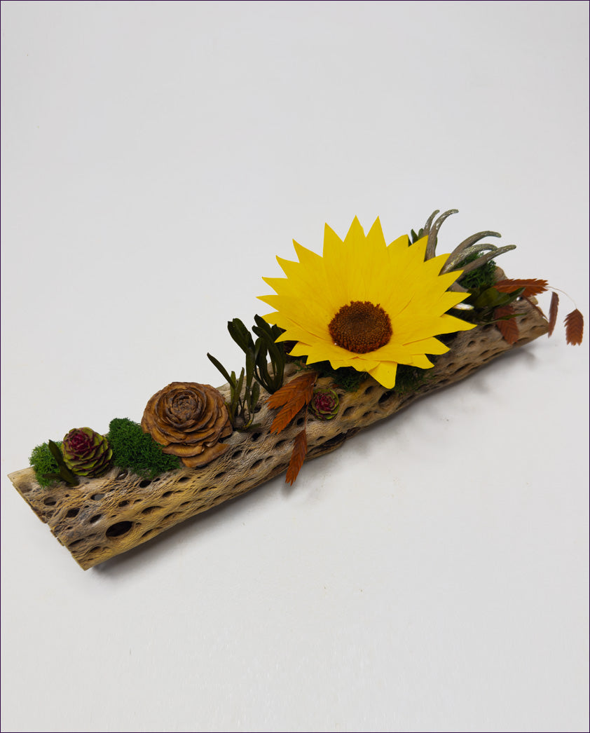 Decorative piece with a sunflower and natural elements on a white background