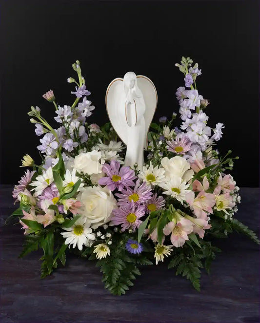 Ceramic angel sympathy floral arrangement from bloombudz in Paragould AR