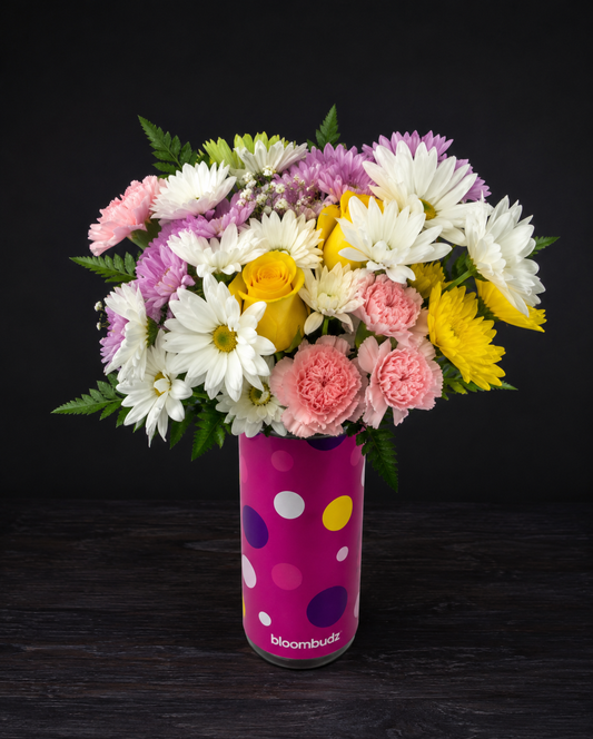 Bouquet of flowers in a polka dot vase on a dark background