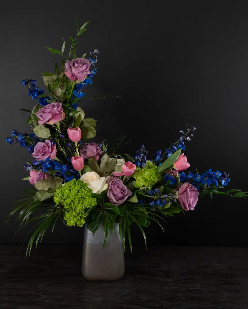 Bouquet of flowers in a vase against a black background