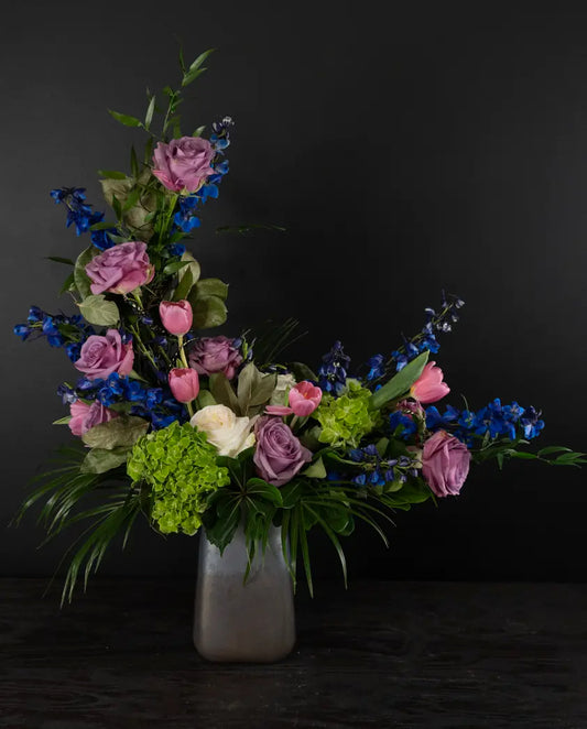 Bouquet of flowers in a vase against a black background