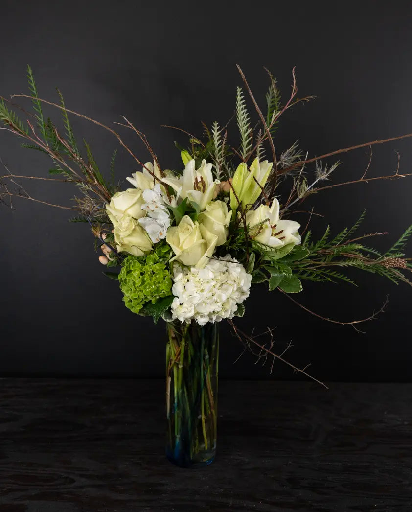 Bouquet of flowers in a vase against a dark background