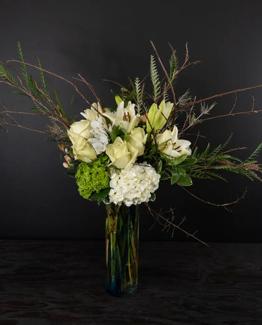 Bouquet of flowers in a vase against a dark background