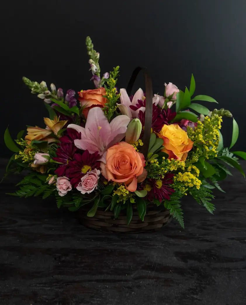 Floral arrangement in a basket on a black background