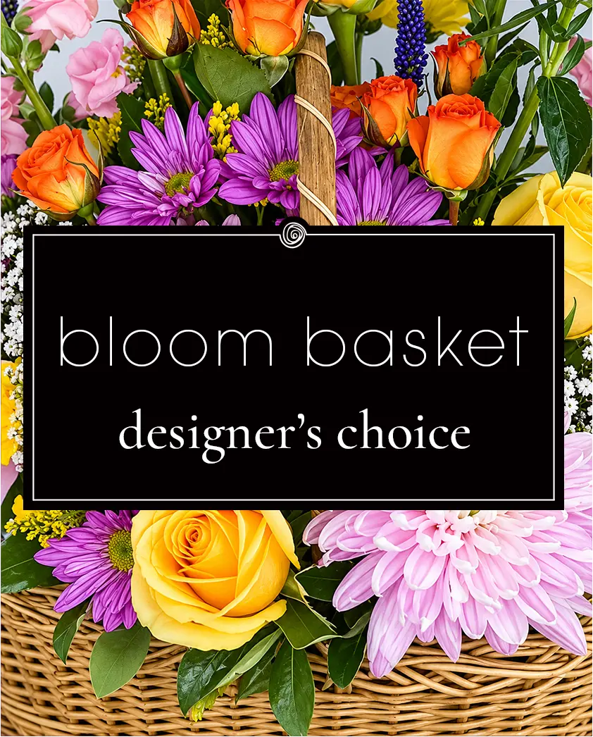 Wicker basket filled with a designer's choice of colorful flowers.